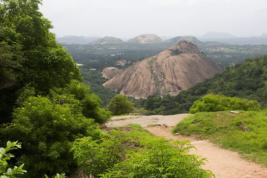 View of green foliage and rocks capes from top of Ramagiri Hill near Ramanagara, Karnataka, India, Asia