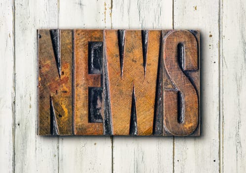 Antique letterpress wood type printing blocks on a white backgound - News