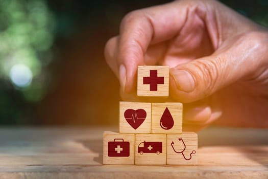 Hand holding cube dice health and medical symbols with copy space.  Healthy and medical concept.
