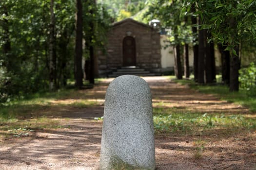 rural road to the gates of the palace with a milestone in the foreground