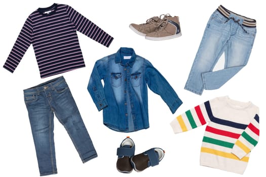 Collage set of children clothes. Denim jeans or pants, two pair shoes, a jeans shirt, striped shirt and a sweater for child boy isolated on a white background. Concept spring autumn and summer clothes.