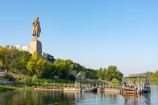 Volgograd, Russia - August 21, 2019: View at dawn on the embankment and the statue of V.I. Lenin in the Krasnoarmeysky district of Volgograd. Sculptor Eugene Vuchetich