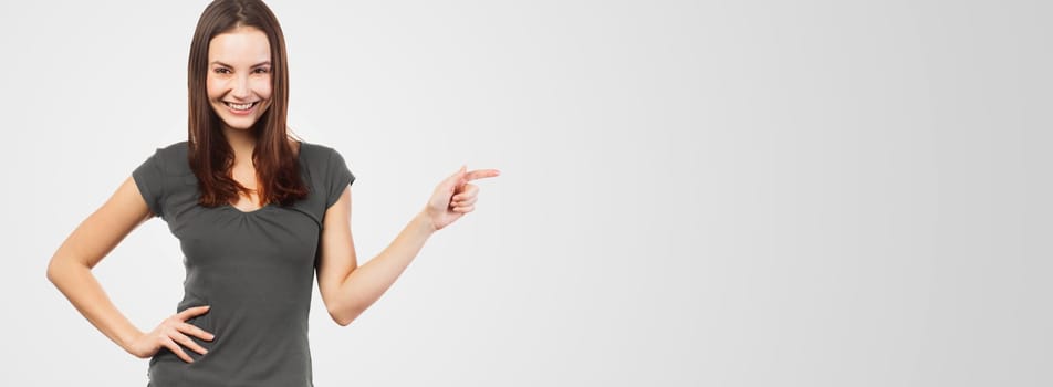 Cheerful woman pointing at copy space