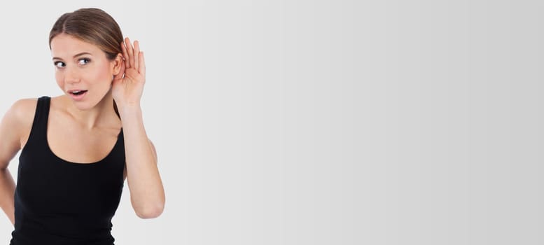Woman curious trying to listen something, isolated on white