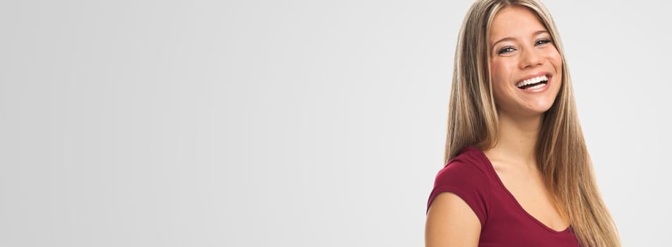 Portrait of a pretty blond young woman , on white