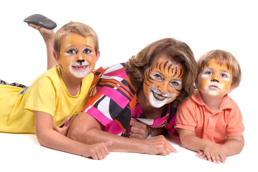 Children's group and grandmother all with animal face-paint isolated in white