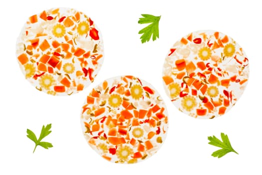 Overtop photograph of three slices of mixed pickles in aspic. backlit on a light table. Isolated on a white background.