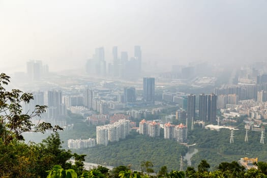 View of the foggy city from the mountains in the early morning, Shenzhen, China, Asia