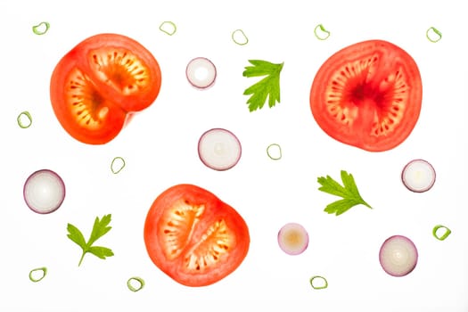 Slices of tomatos, red scallions and parsley leaves as tomato salad ingredians. Backlit on a light table. Isolated on a white background.