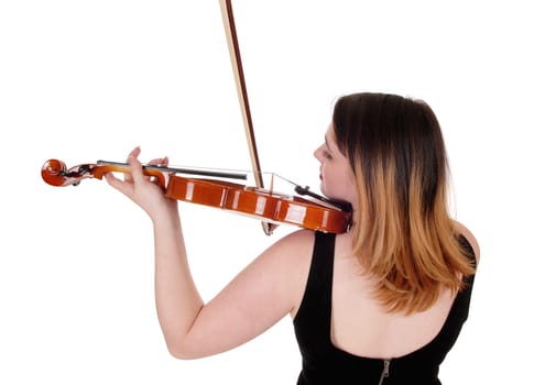 A young woman standing from the back in a close up image playing.the violin with her blond hair, isolated for white background.