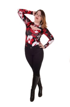 A gorgeous young woman standing isolated for white background with.one hand on her head in black tights and boots.