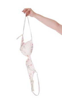 A single womans hand holding up a white bra with flowers printed on.body part, isolated for white background.