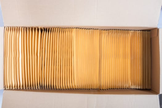 Opened box with many brown bubble envelopes