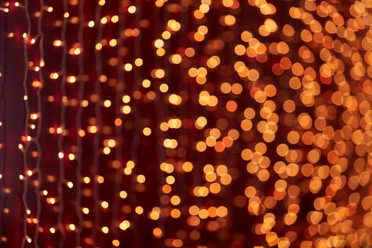 Festive background with LED lights garland. Christmas and New Year background. Blurred bokeh from the lights of a garland.