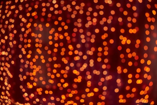 Festive background with LED lights garland. Christmas and New Year background. Blurred bokeh from the lights of a garland.