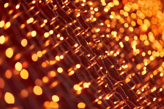 Festive background with LED lights garland. Christmas and New Year background. Blurred bokeh from the lights of a garland.