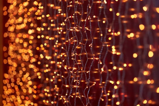 Festive background with LED lights garland. Christmas and New Year background. Blurred bokeh from the lights of a garland.