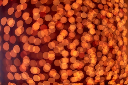 Festive background with LED lights garland. Christmas and New Year background. Blurred bokeh from the lights of a garland.