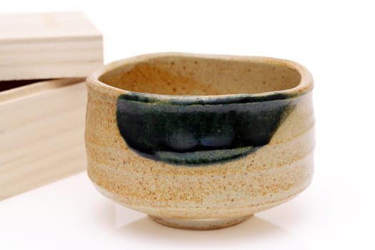 Single tea bowl used in Japanese matcha tea ceremony on white hackgrond