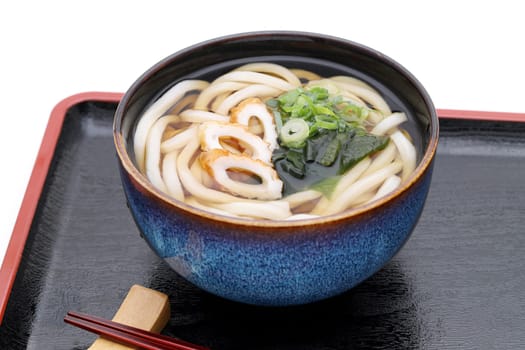 Japanese Kake udon noodles in a ceramic bowl on wooden tray