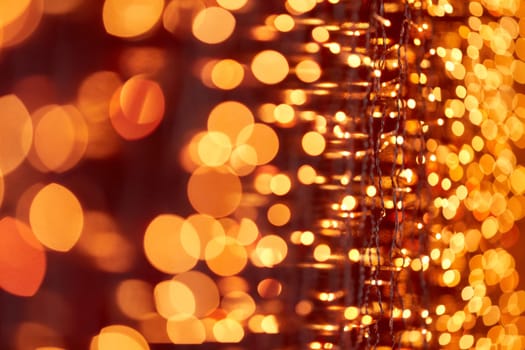 Festive background with LED lights garland. Christmas and New Year background. Blurred bokeh from the lights of a garland.