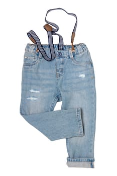 Jeans isolated. Trendy stylish blue denim pant or trousers for child boy with striped suspenders isolated on a white background. Jeans summer and autumn fashion. Front view.