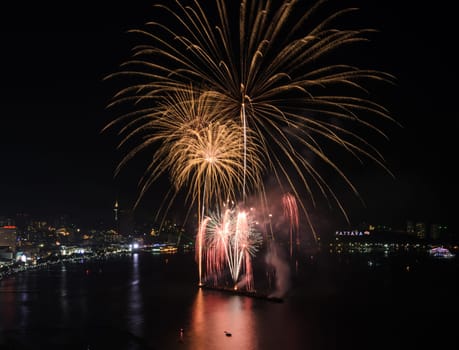 Big firework on the sky at Pattaya coast with cityscape background, Thailand