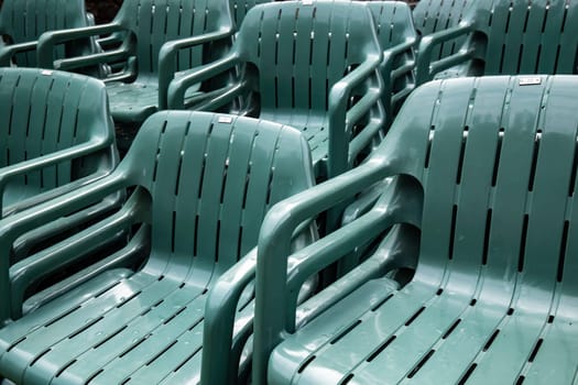Stacked green plastic chairs in detail