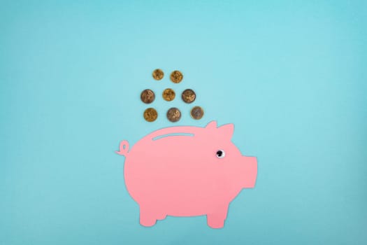 Cut out Paper Piggy Bank with Euro Coins on light Blue Background
