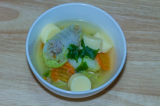 Clear soup with bean curd and minced pork on wooden