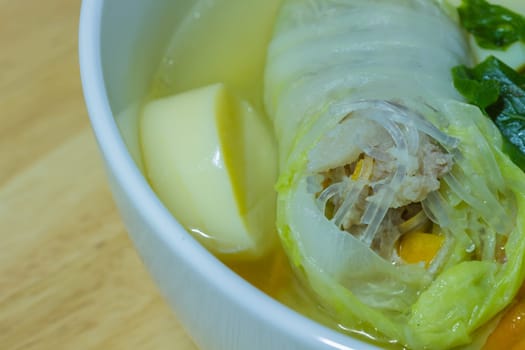 Clear soup with bean curd and minced pork on wooden
