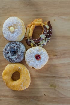 Donuts on wooden background, closeup Delicious a lot of donuts