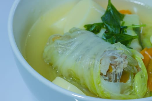 Clear soup with bean curd and minced pork on wooden
