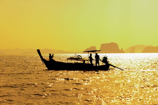 Longtail boat on sunrise on the coast of Andaman sea in Thailand