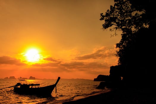 Longtail boat on sunrise on the coast of Andaman sea in Thailand