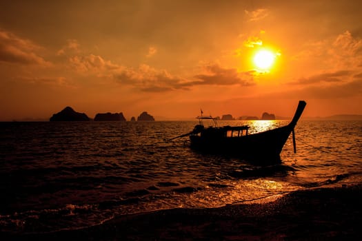 Longtail boat on sunrise on the coast of Andaman sea in Thailand