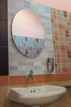 Bathroom at office.Handbasin and mirror in toilet