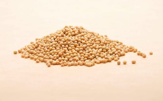 Mustard seeds on brown background