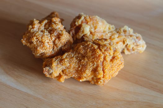Fresh fried chicken on a wood table background