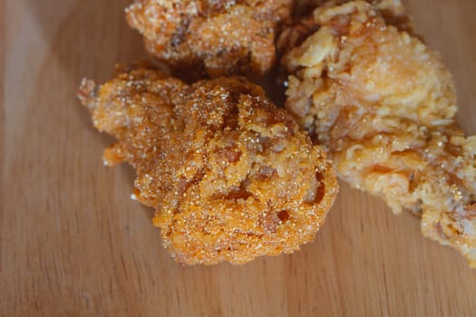 Fresh fried chicken on a wood table background
