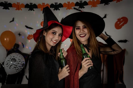 Group of young adult and teenager people celebrating a Halloween party carnival Festival in Halloween costumes drinking alcohol beer