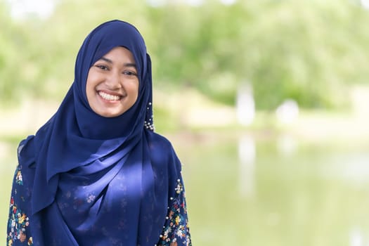 Portrait of good-looking Happy young teenager Muslim islamic asian university girl