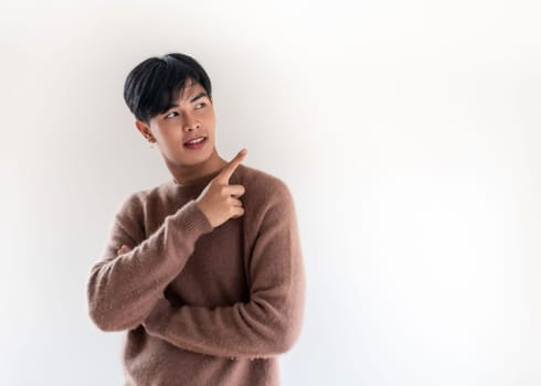 Portrait of good-looking smart Teenager young asian adult boy wearing brown sweater for winter on white background