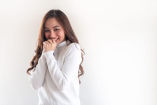 Portrait of good-looking beautiful young asian adult girl wearing white sweater for winter on white background