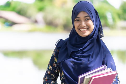 Portrait of good-looking Happy young teenager Muslim islamic asian university girl