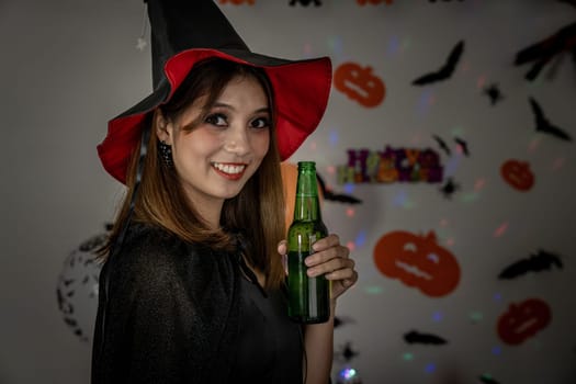 Young adult and teenager girl celebrating a Halloween party carnival Festival in Halloween costumes drinking alcohol beer