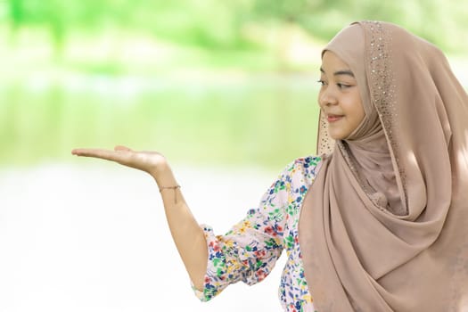 Portrait of good-looking Happy young teenager Muslim islamic asian university girl