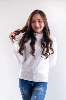 Portrait of good-looking beautiful young asian adult girl wearing white sweater for winter on white background