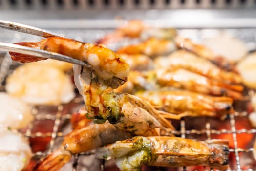 grilled japanese tiger prawn and hokkaido scallop yakiniku with red hot charcoal
