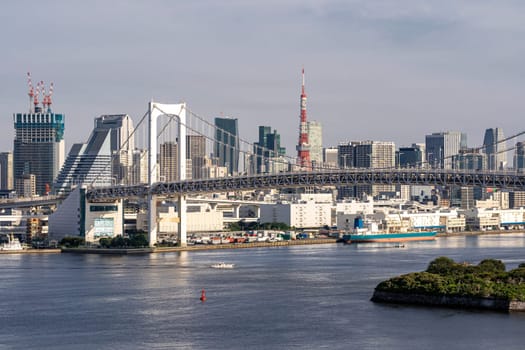 Aerial view of Tokyo skylines with Rainbow bridge and tokyo tower over Tokyo bay in daytime from Odaiba in Tokyo city Kanto Japan.